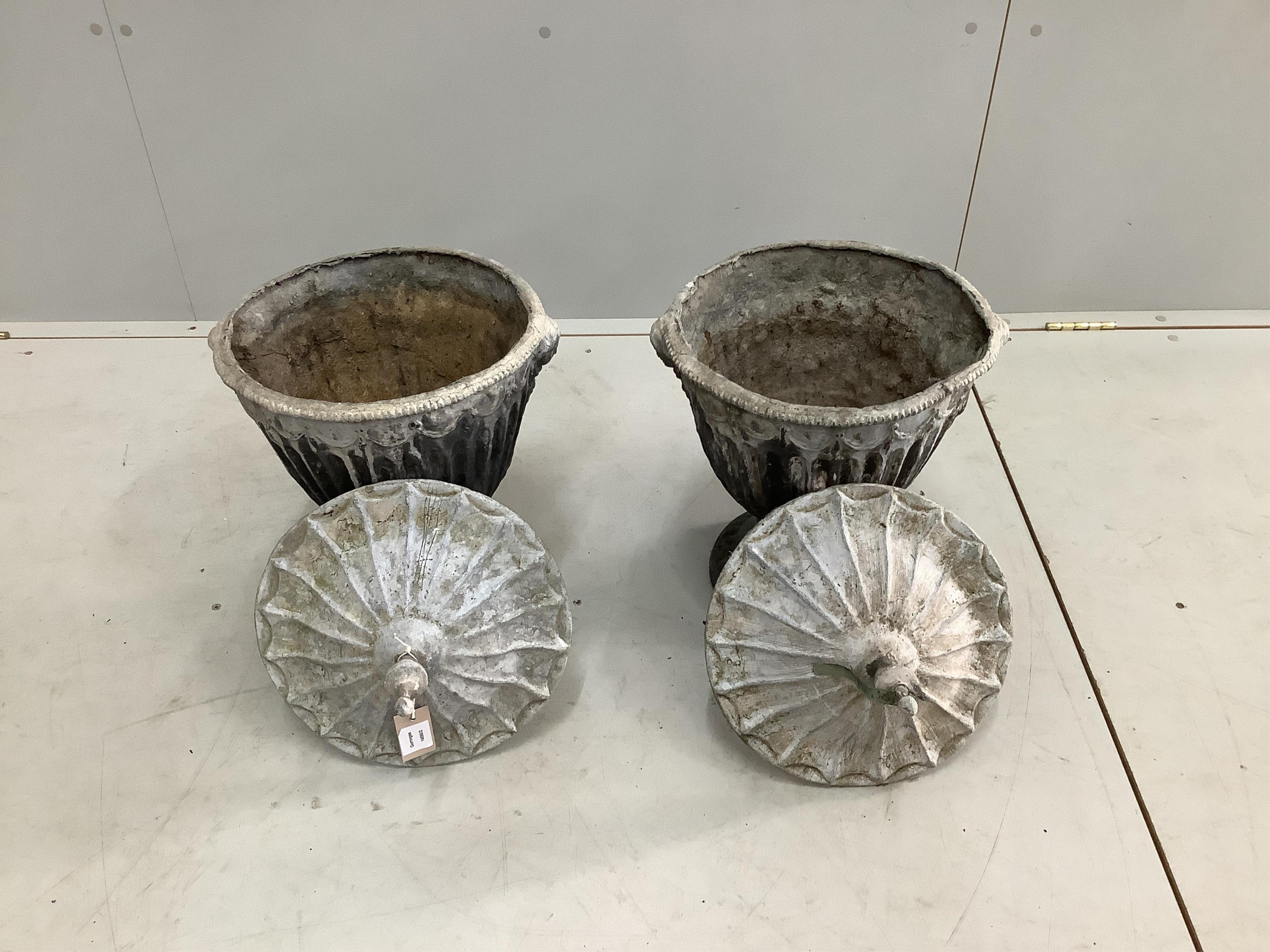 A pair of 19th century lead urns and covers, height 52cm. Condition - fair